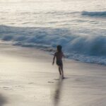 boy runing on the beach
